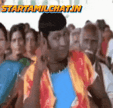 a man giving the middle finger in front of a crowd with the words starttamilchatin written above him
