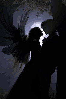 a silhouette of a man and a woman with angel wings