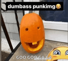 a pumpkin with a face carved into it and the words `` dumbass punking '' written above it .