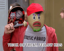 a man holding a skateboard and wearing a music band shirt