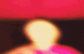 a blurry picture of a person 's face with a red background