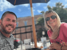 a man wearing a chicago white sox shirt smiles next to a woman