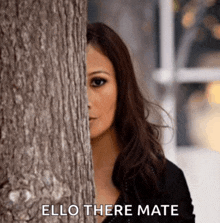 a woman peeking out from behind a tree with the words " ello there mate " written below her