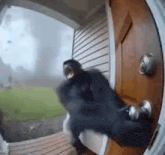 a person is standing in front of a door with a storm coming in the background .