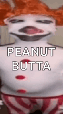 a clown with red hair is wearing a peanut butta costume .