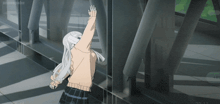 a girl in a school uniform is standing in front of a metal structure with her arms outstretched