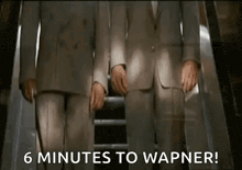 two men in suits are standing on an escalator with the words `` 6 minutes to wagner ! ''