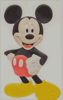 a picture of mickey mouse holding a red ball and yellow shoes