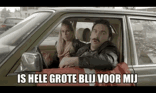 a man and a woman are in a car with the words is hele grote blij voor mij