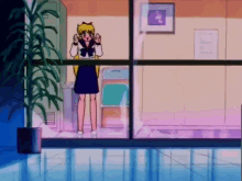 a girl in a sailor suit is standing in front of a glass door