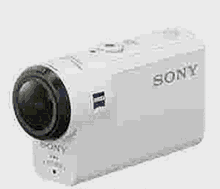 a white sony camera is sitting on a table .