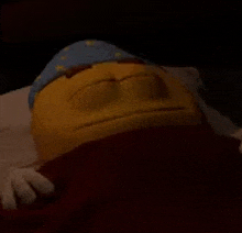 a stuffed smiley face is laying on a bed with its eyes closed and wearing a sleep cap .