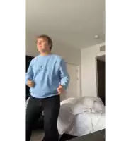 a man wearing a blue sweatshirt that says " i love you " on it