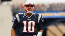 a man wearing a patriots jersey and helmet