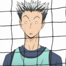 a close up of a person behind a volleyball net with a surprised look on their face .