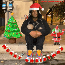 a man wearing a santa hat sits in front of a christmas tree with the words merry christmas below him