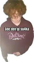 a person wearing a purple detroit sweatshirt with a white background