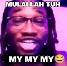 a close up of a man wearing glasses and a purple background with the words `` mulai lah tuh my my my '' .