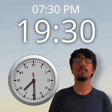 a man is standing in front of a clock that says 19:30 pm