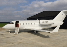 a white private jet with the letters n247cr on the tail