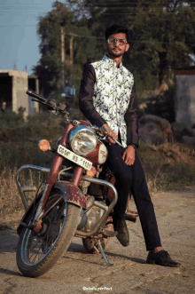 a man sitting on a red motorcycle with a license plate that says cg df ks 1131