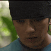 a close up of a man 's face with a black hat on