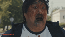 a close up of a man with blood on his face and the words #weaponsmovie below him
