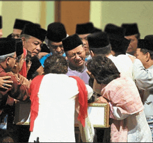 a group of people wearing black hats are gathered around a frame