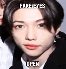 a close up of a person 's face with a meme that says fake eyes open