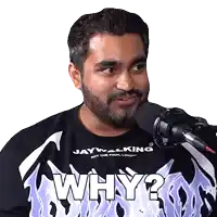 a man with a beard wearing a black shirt that says why