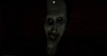 a close up of a scary face with glowing eyes and a smile .