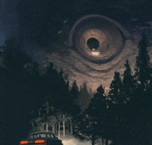 a car is driving through a dark forest with a giant eye above it