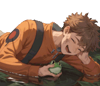 a boy is laying on the ground holding a frog in his hand