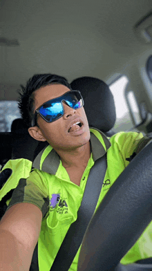 a man wearing sunglasses and a yellow shirt that says ' eaa ' on it