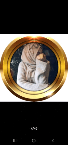 a picture of a woman in a hijab is displayed in a gold frame