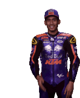 a man wearing a red bull ktm jacket and hat