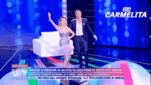 a man and a woman are dancing on a stage with zia carmelita written on the bottom