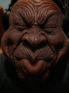 a close up of an old man 's face with headphones