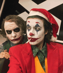 two men dressed up as the joker and the joker wearing a santa hat