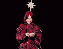 a person in a red plaid shirt is holding christmas lights