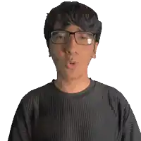 a man wearing glasses and a black shirt with the name quinn on it