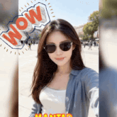 a woman wearing sunglasses is taking a selfie with a wow speech bubble behind her