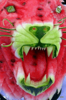 a watermelon carved into the shape of a tiger 's head