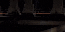 a dark tunnel with a few lights on the side of it