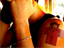 a person with a tattoo of a roblox character on their shoulder