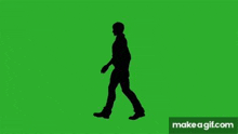 a man is walking on a green screen .