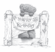 a teddy bear is holding a sign that says `` happy birthday '' .