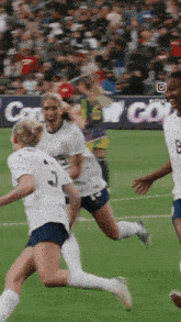 a group of soccer players are running on a field with a sign in the background that says ' content '