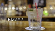 a glass of fizzy drink with a straw