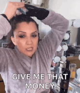 a woman in a robe is holding a bottle of wine and says give me that money